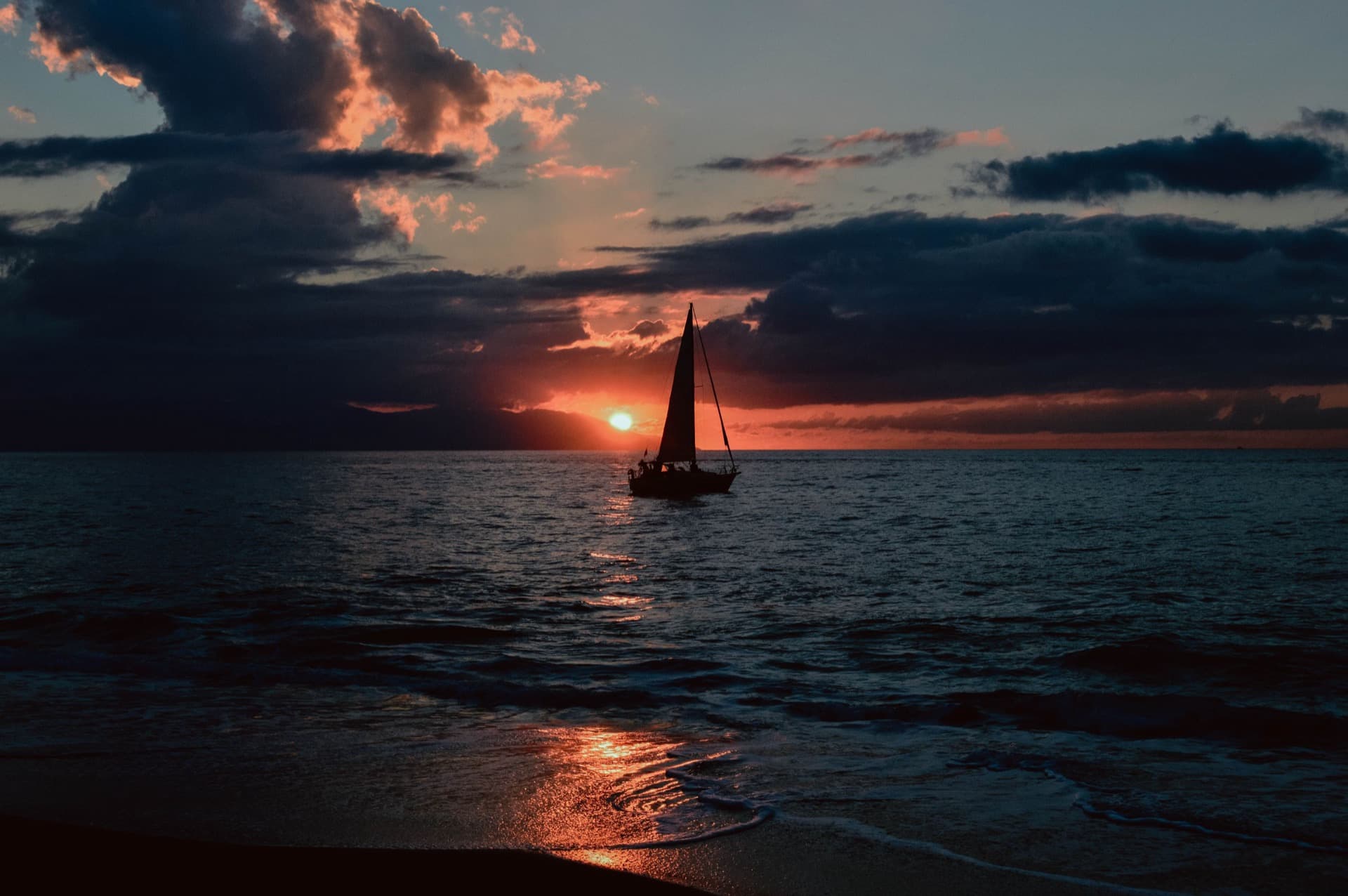 A sailboat silhouetted at sunset off Puerto Vallarta