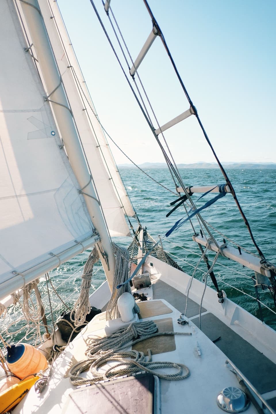 A sailboat's bow under way, with lines and the headsail